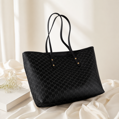 Black quilted handbag on a light background