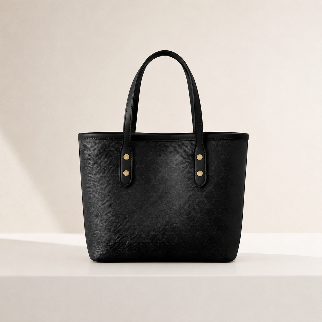 Black leather tote bag on a light beige background