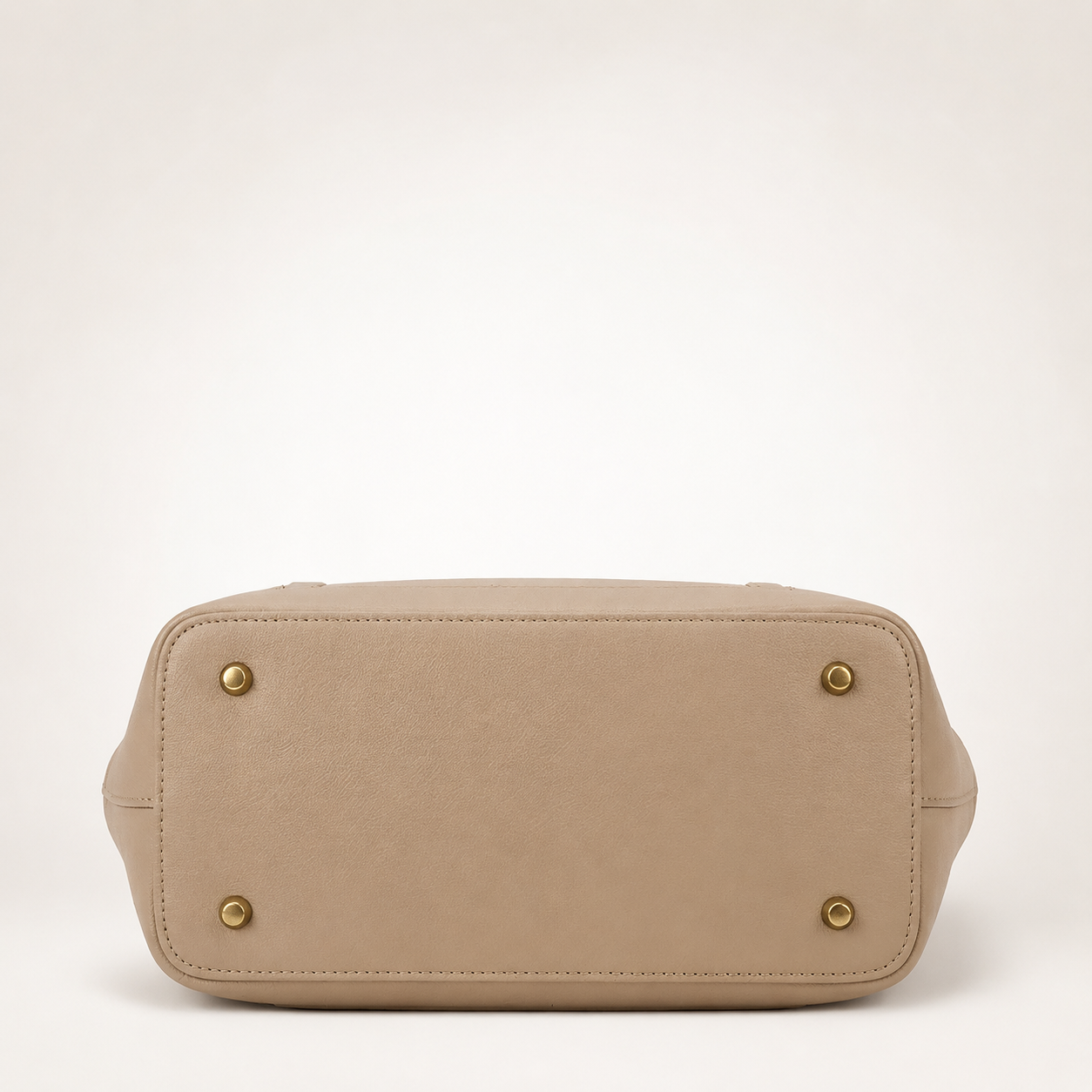 Beige handbag with gold accents on a white background