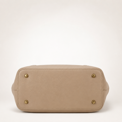 Beige handbag with gold accents on a white background
