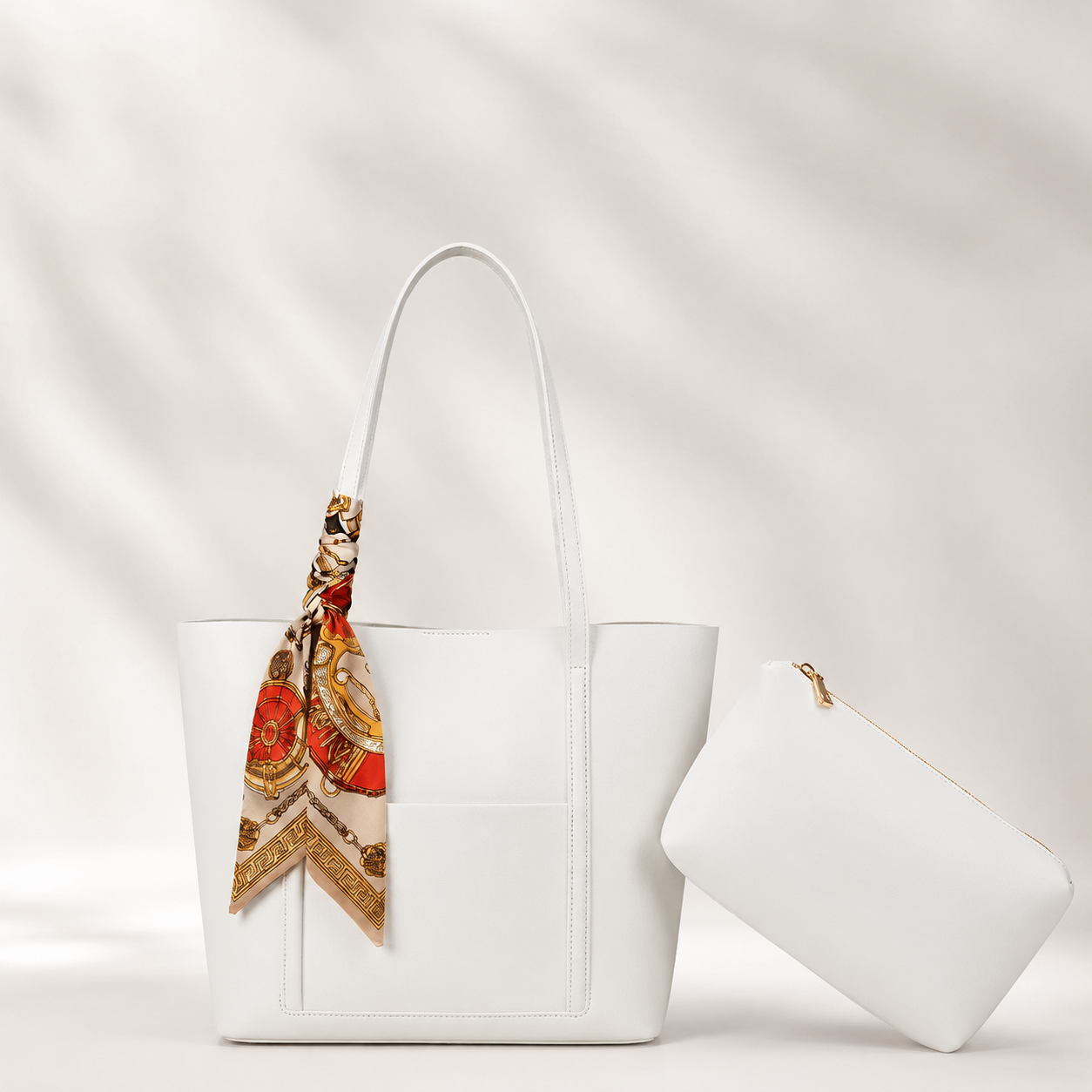 White handbag with a colorful scarf draped over it on a light background