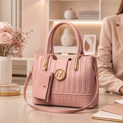 Pink handbag with gold accents on a table in an elegant room setting.