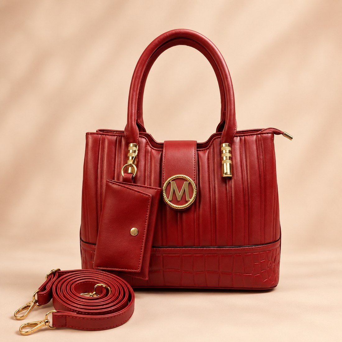 Red handbag with gold accents on a beige background