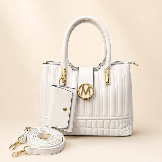 White handbag with gold accents on a beige background