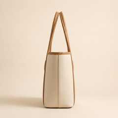 Beige tote bag with brown handles on a beige background