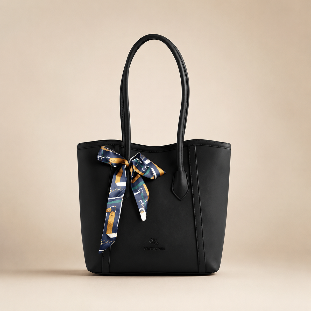 Black handbag with a decorative ribbon on a beige background