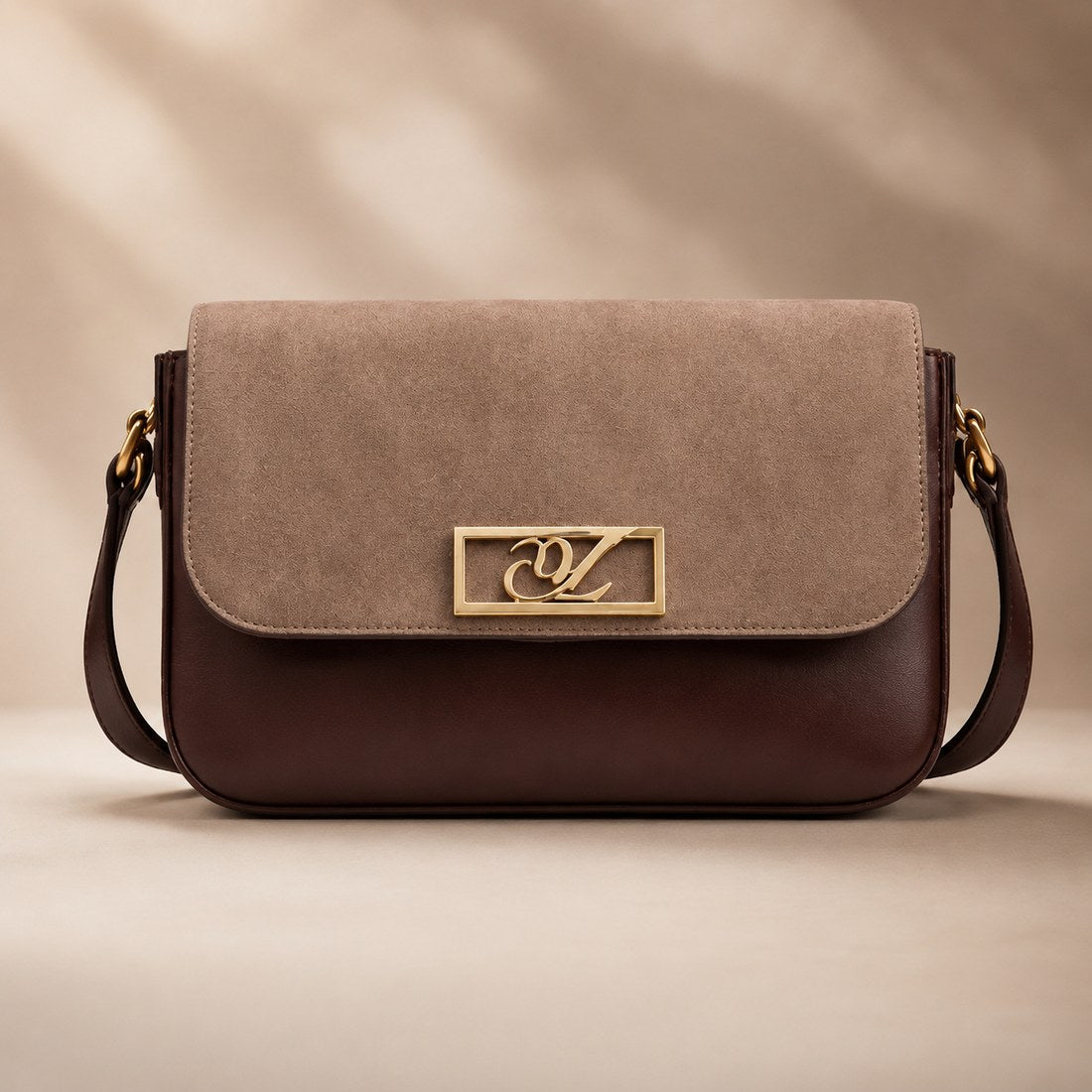 Two-tone handbag with a gold clasp on a beige background