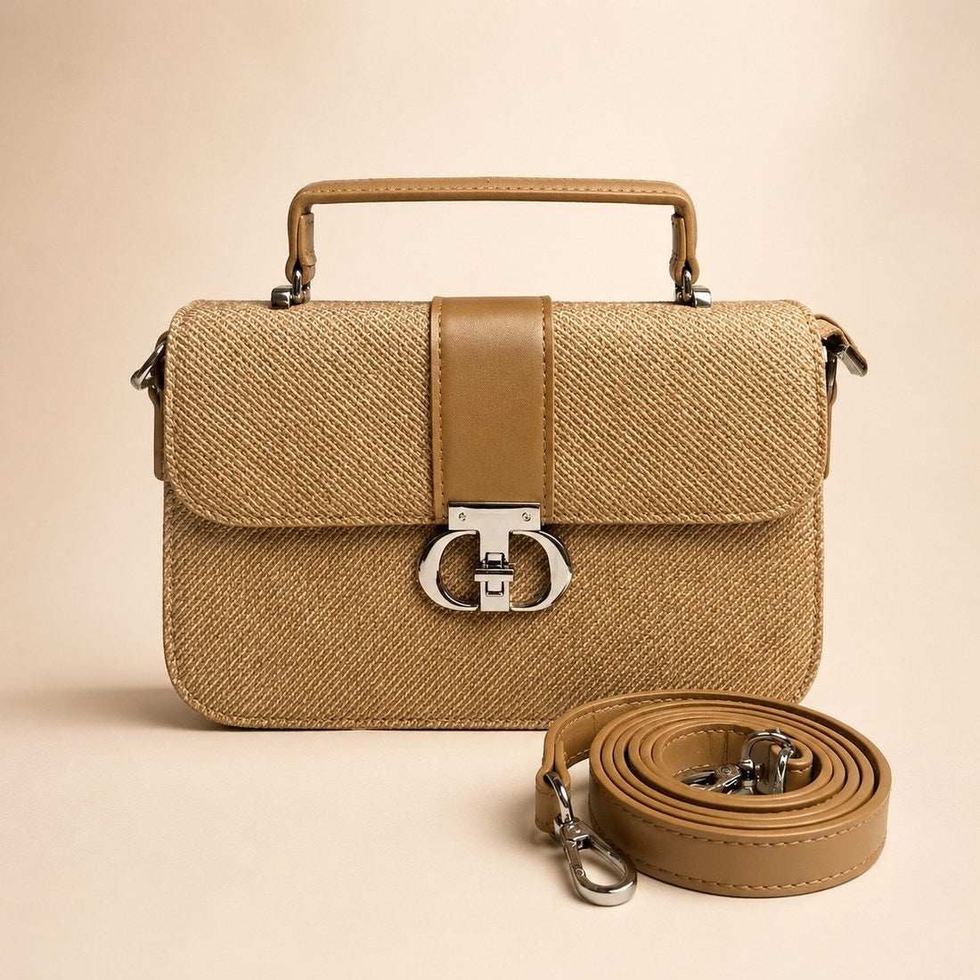 Beige handbag with matching strap on a beige background