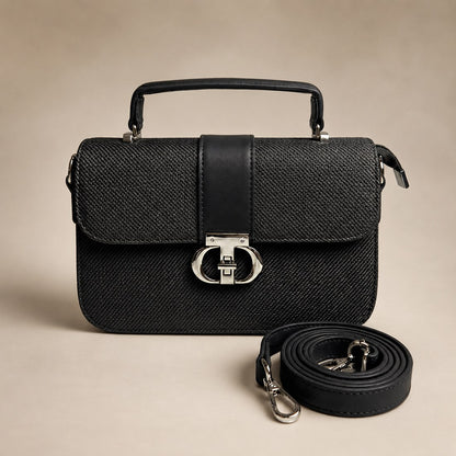 Black textured handbag with a strap on a beige background
