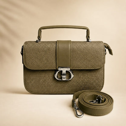 Green handbag with matching strap on a beige background