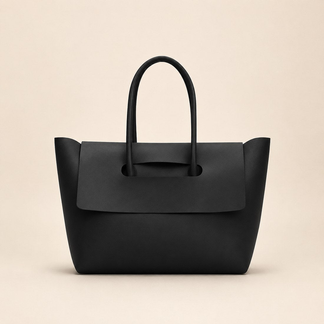 Black handbag on a beige background