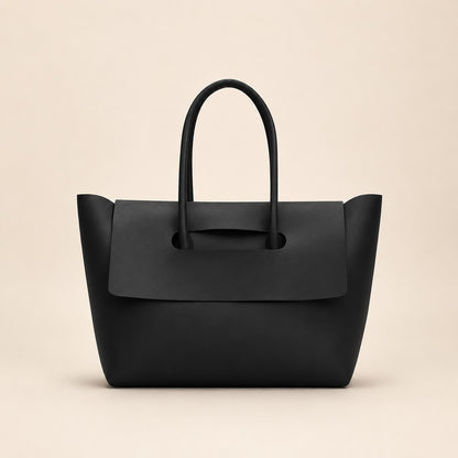 Black handbag on a beige background