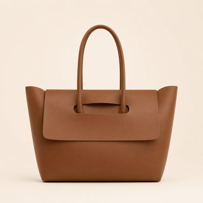 Brown leather handbag on a beige background